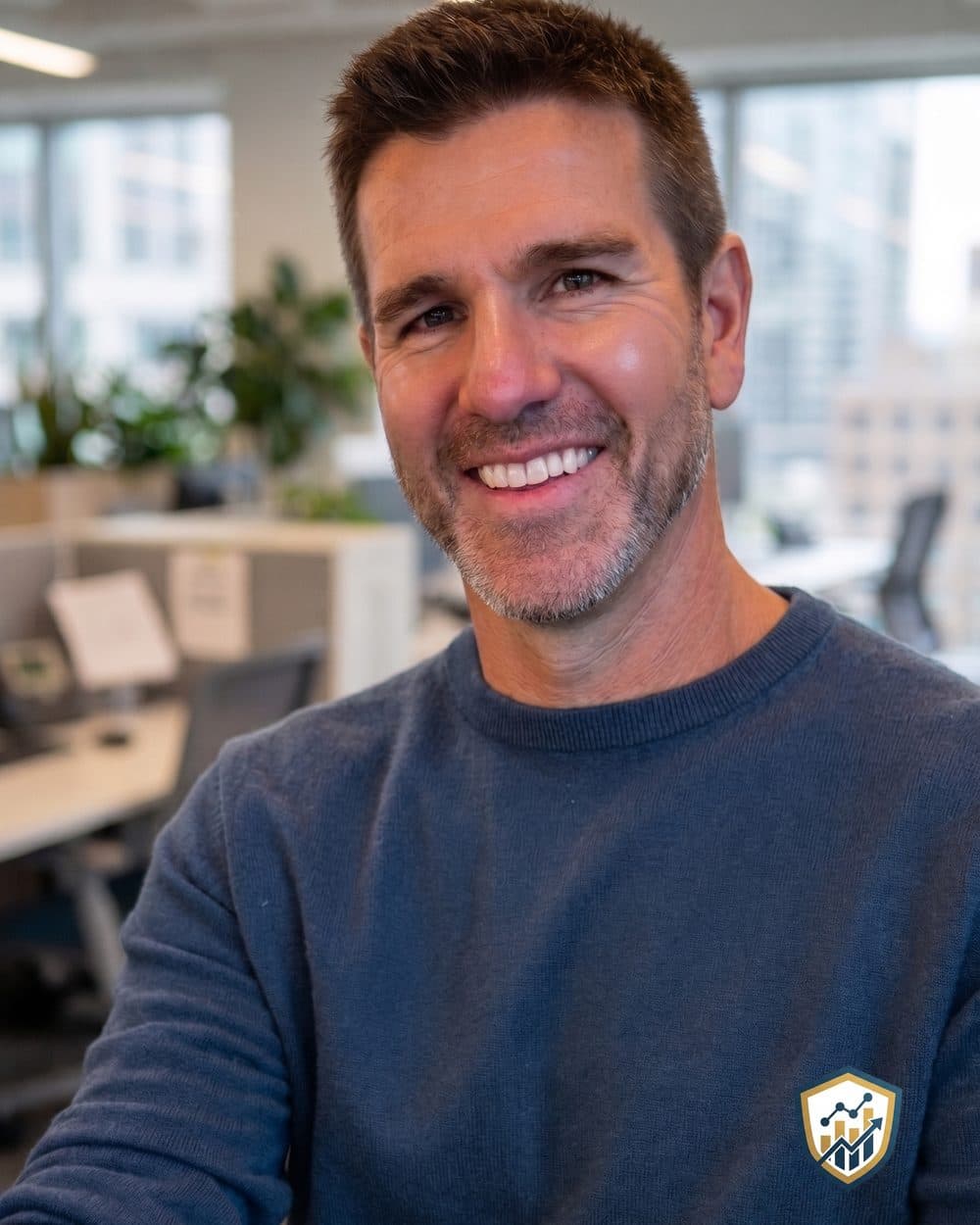 Eric Nasalroad, founder of Nasalroad Advisory, in a blue sweater with the Nasalroad shield logo